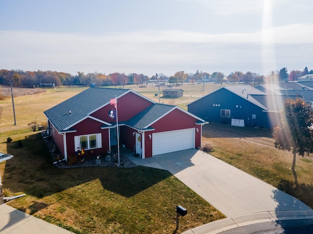 view of front of property featuring a front yard and a garage