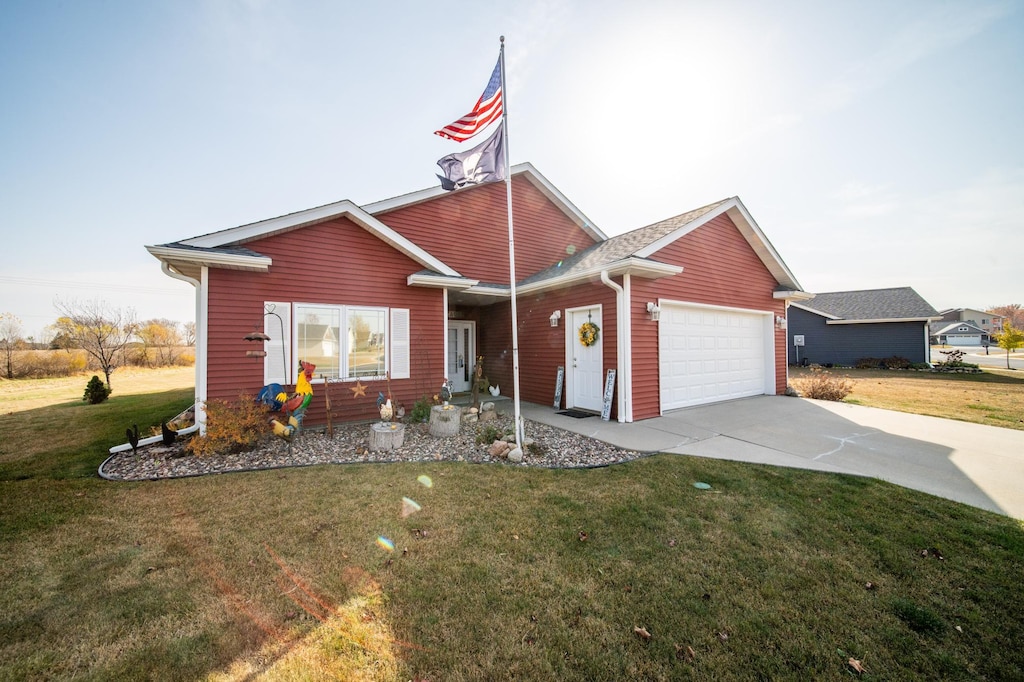 view of front facade featuring a garage and a front lawn