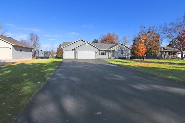 ranch-style house featuring a garage and a front yard