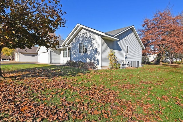 view of property exterior with a lawn, cooling unit, and a garage