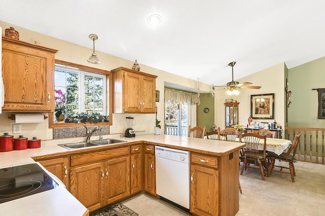 kitchen featuring dishwasher, kitchen peninsula, a wealth of natural light, and decorative light fixtures