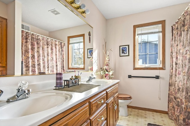 bathroom with vanity and toilet