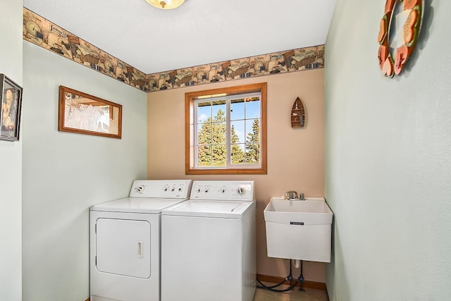 laundry room featuring sink, washing machine and clothes dryer, and a textured ceiling