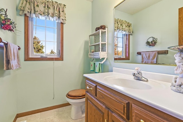 bathroom featuring toilet, vanity, and tile patterned floors