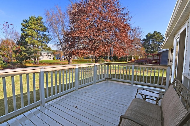 wooden deck featuring a yard