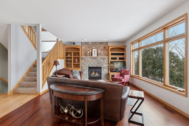 living room featuring a fireplace and dark hardwood / wood-style floors