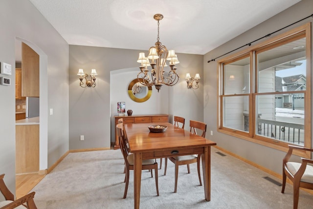 carpeted dining space with an inviting chandelier, vaulted ceiling, and a textured ceiling