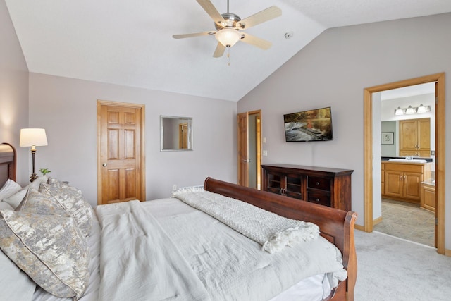 bedroom featuring lofted ceiling, light colored carpet, connected bathroom, and ceiling fan