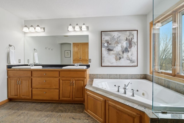 bathroom featuring vanity and a relaxing tiled tub