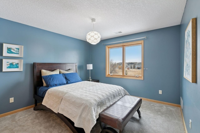 carpeted bedroom featuring a textured ceiling