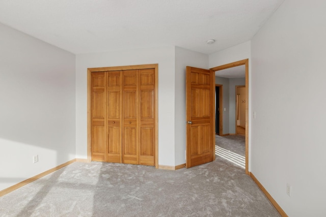 unfurnished bedroom featuring a closet and carpet flooring