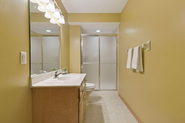 bathroom with tile patterned flooring, vanity, an enclosed shower, and toilet