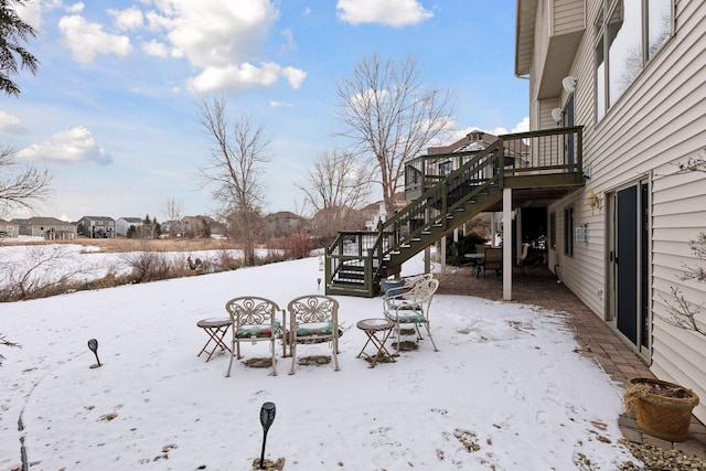 yard layered in snow with a wooden deck