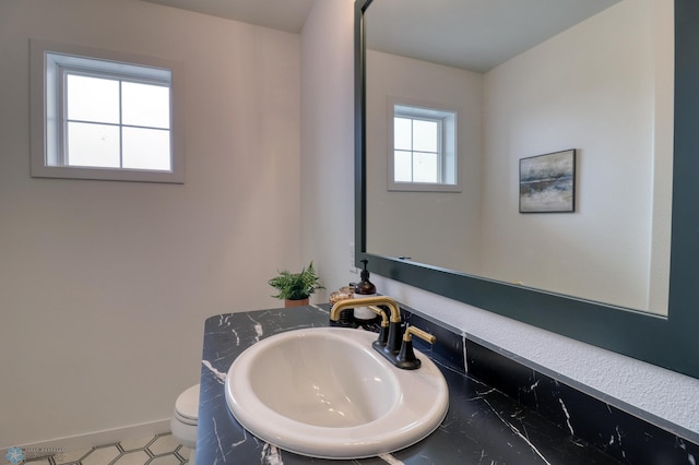 bathroom with toilet and vanity