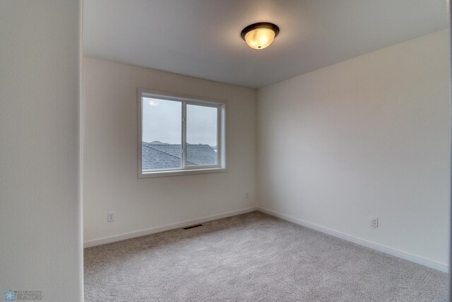 spare room with light carpet