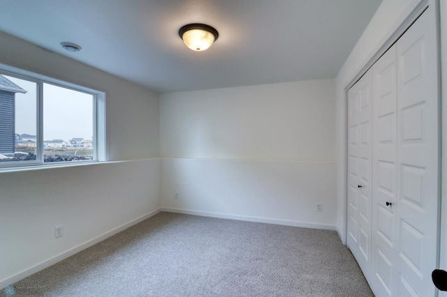 unfurnished bedroom with a closet and carpet floors