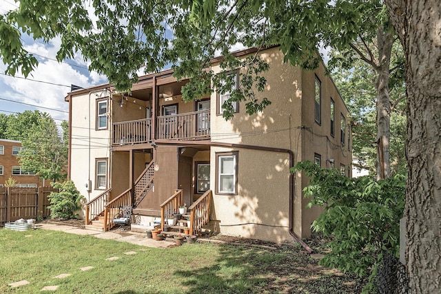 rear view of house with a yard