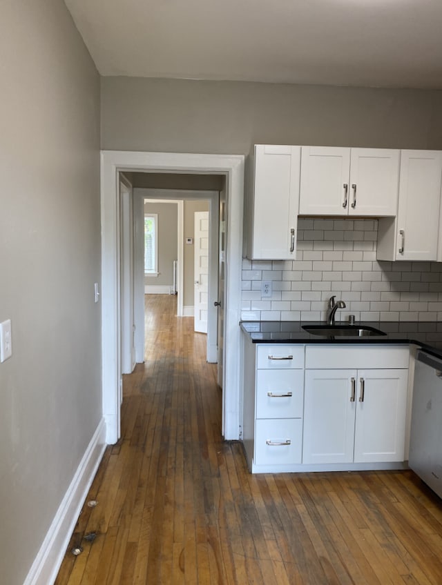 kitchen featuring white cabinetry, sink, and dark wood-type flooring