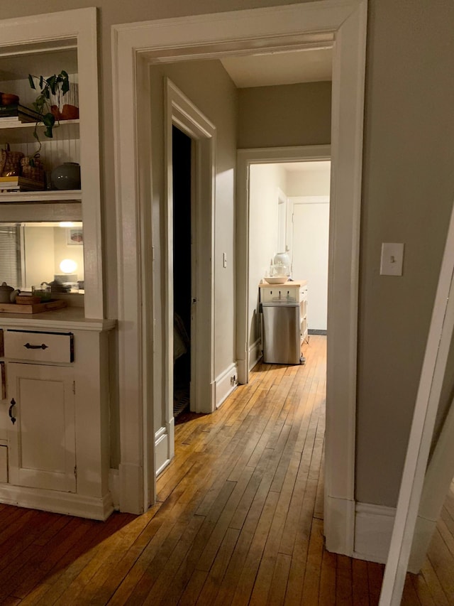 corridor with light hardwood / wood-style floors