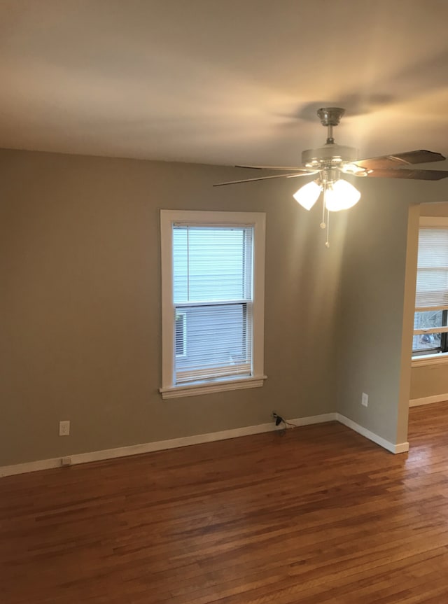 spare room with hardwood / wood-style floors and ceiling fan