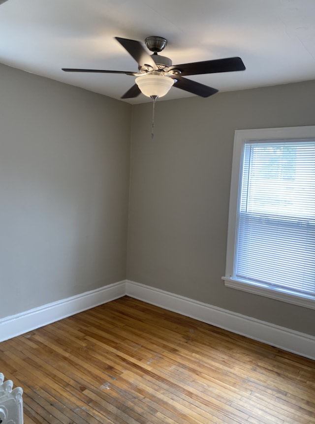 spare room with light wood-type flooring and ceiling fan