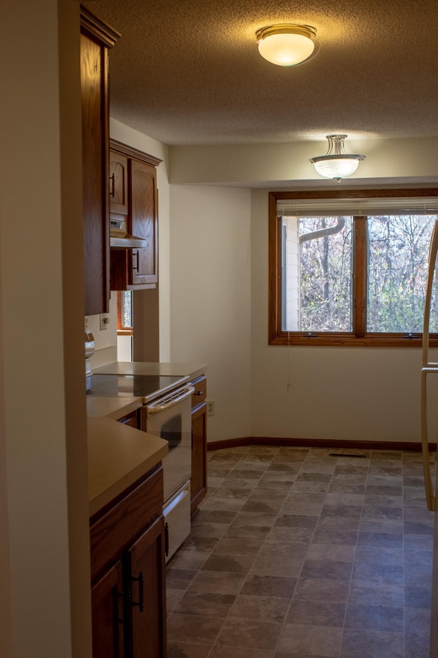 kitchen featuring electric range and a textured ceiling