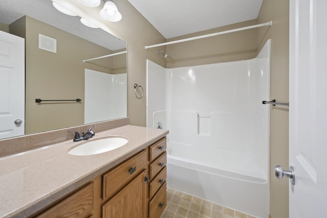 full bath featuring a textured ceiling, tub / shower combination, vanity, and visible vents