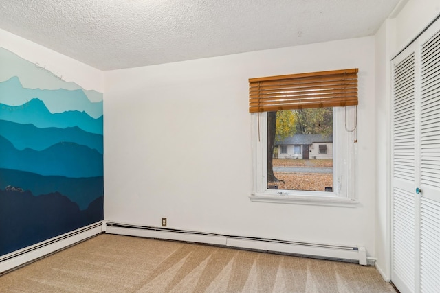 unfurnished bedroom featuring light carpet, a closet, a textured ceiling, and a baseboard heating unit