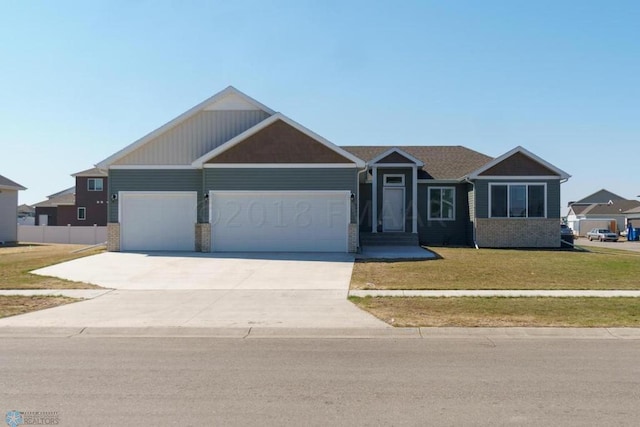 view of front of property with a front yard and a garage