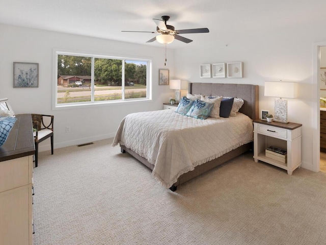 bedroom featuring ceiling fan and light carpet