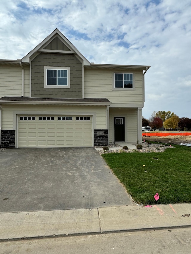 view of front of house featuring a garage and a front lawn