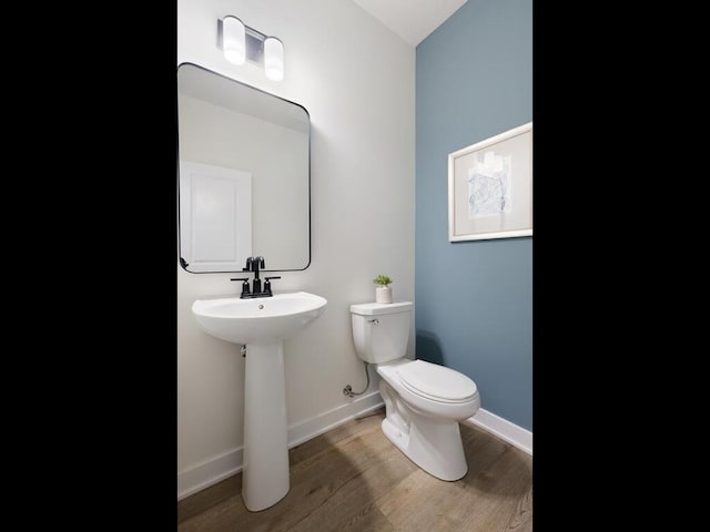 bathroom with toilet, lofted ceiling, and hardwood / wood-style flooring