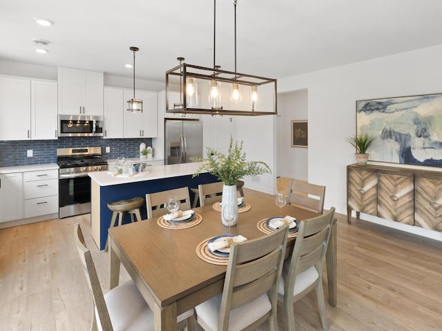 dining space with light hardwood / wood-style floors