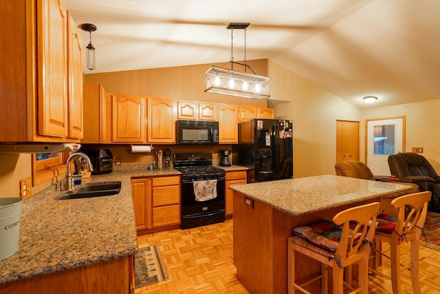 kitchen with black appliances, light parquet floors, hanging light fixtures, sink, and vaulted ceiling