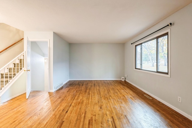 spare room with light hardwood / wood-style flooring