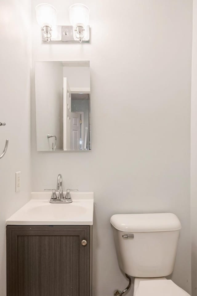 bathroom featuring toilet and vanity