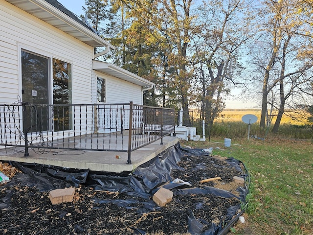 yard at dusk featuring a deck