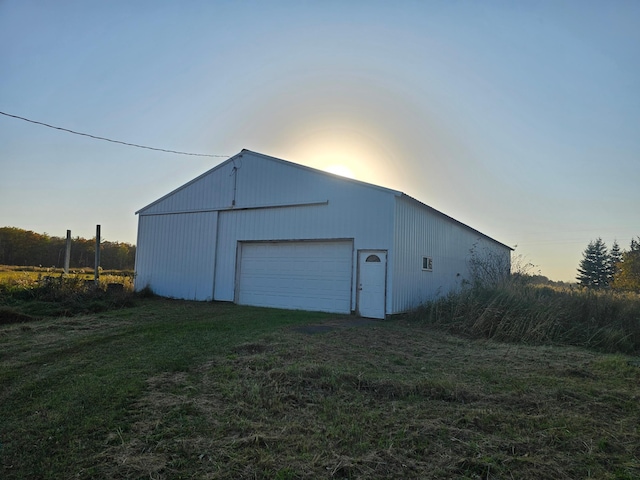 garage at dusk with a lawn