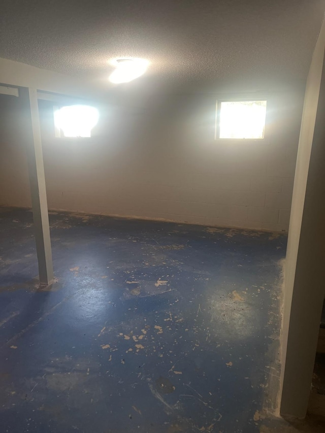 basement featuring a textured ceiling