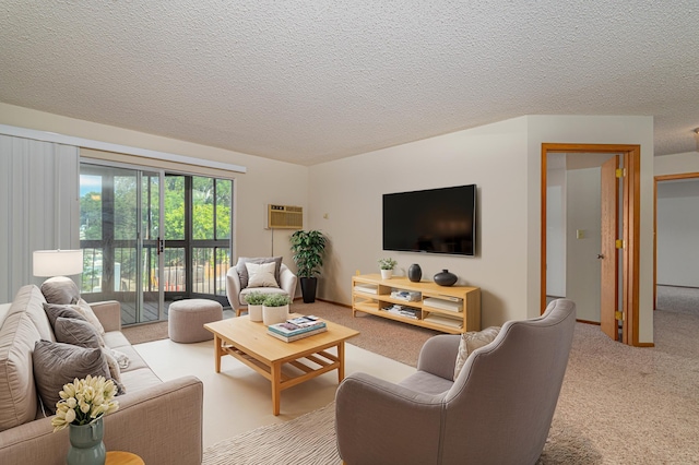 carpeted living room featuring a textured ceiling and a wall mounted AC