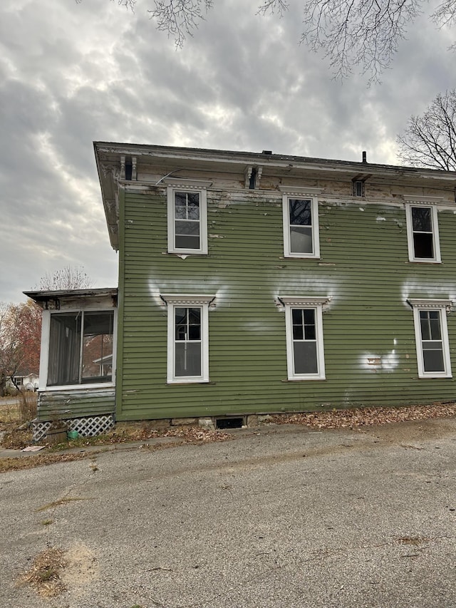 view of side of home featuring a sunroom