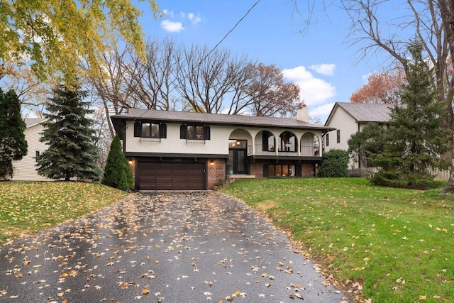 split foyer home featuring a garage and a front yard