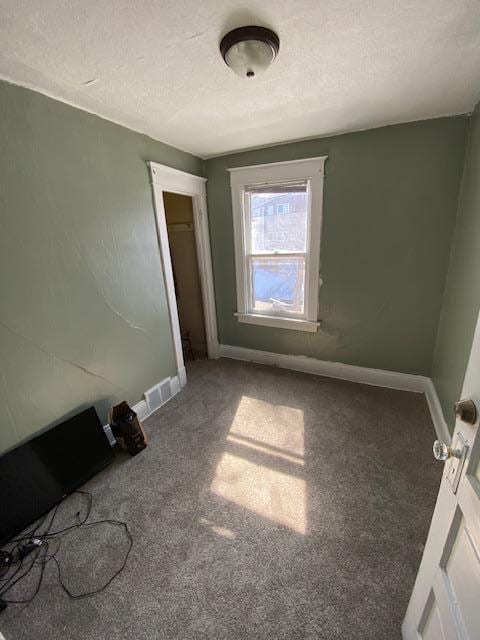 unfurnished bedroom featuring carpet and a closet