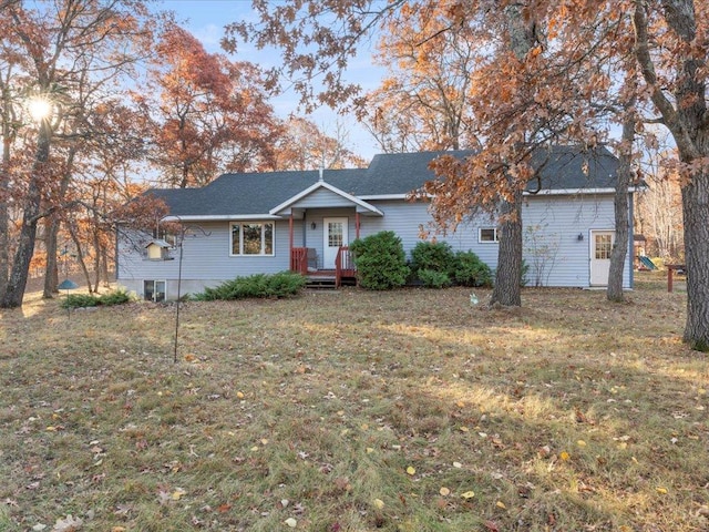 ranch-style house with a deck and a front lawn