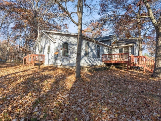 back of property featuring a deck