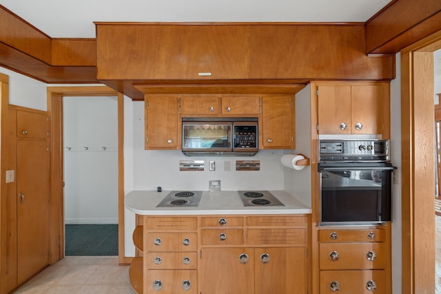 kitchen with electric cooktop and black oven