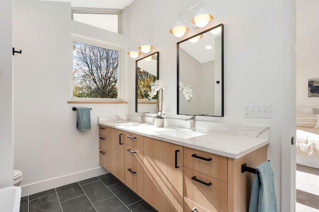 bathroom with tile patterned flooring, vanity, toilet, and vaulted ceiling