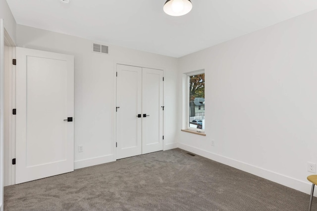 unfurnished bedroom with carpet and a closet