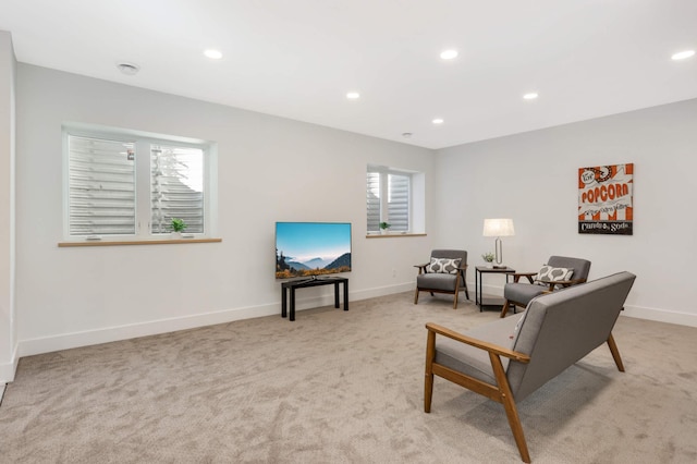 living area with light carpet and a healthy amount of sunlight