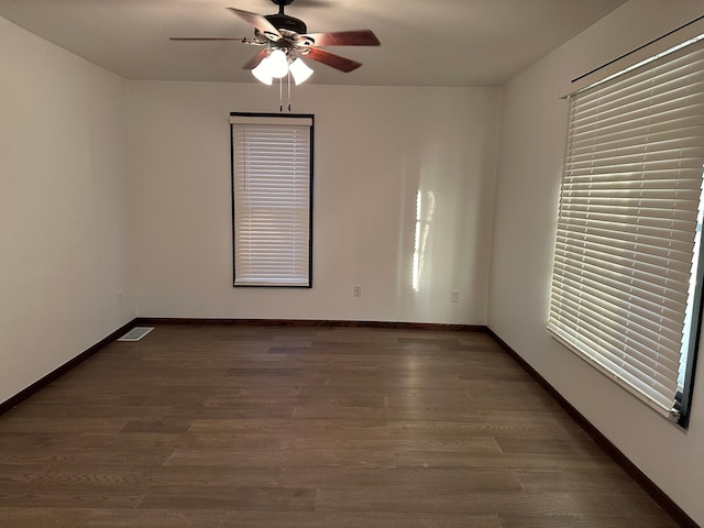 unfurnished room featuring ceiling fan and dark hardwood / wood-style floors